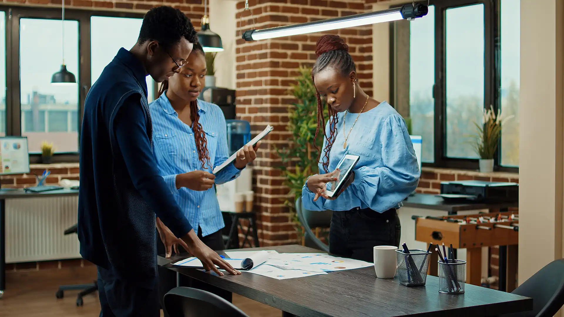 Small business team reviewing work together in a creative workspace