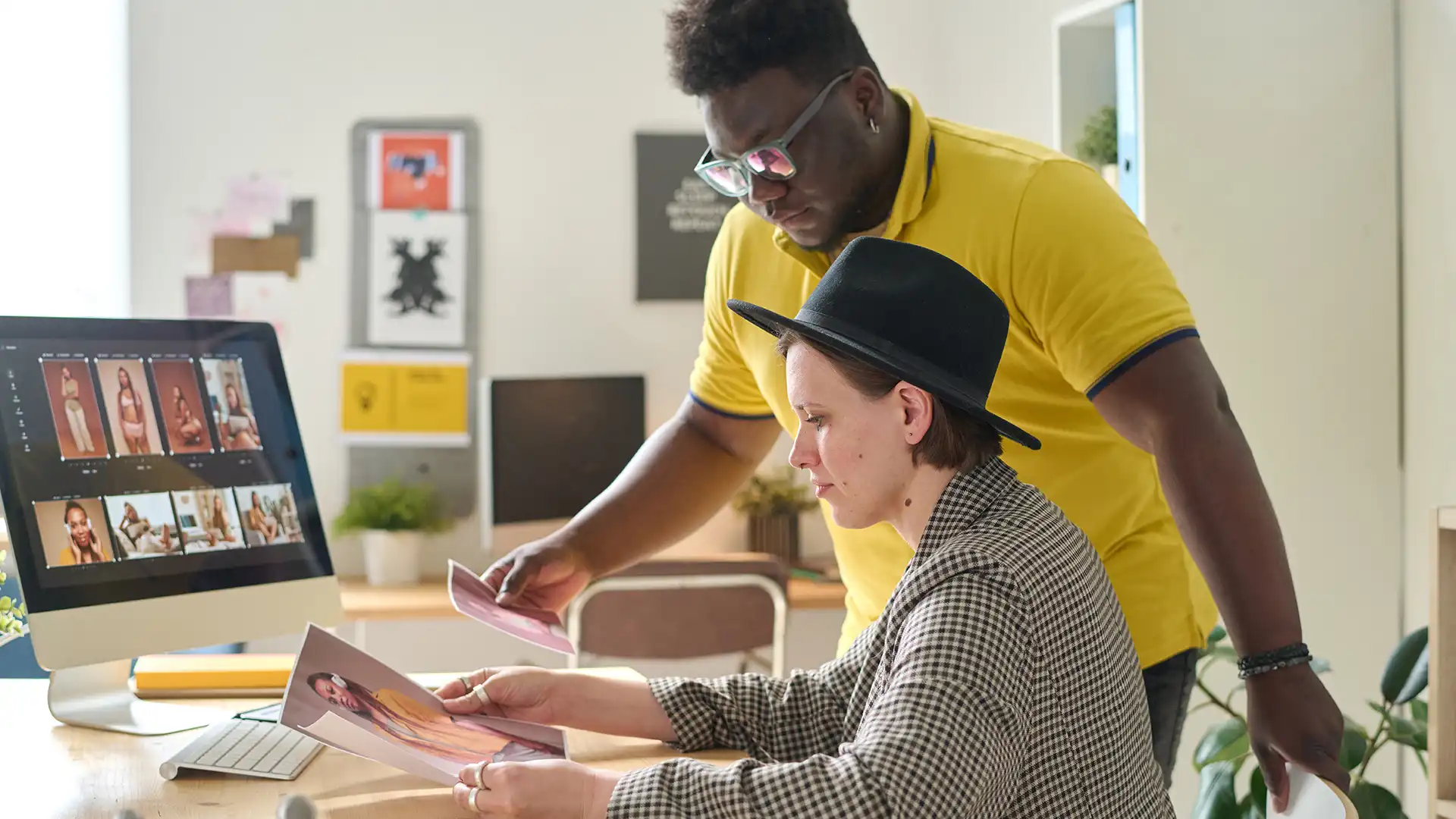 Designers collaborating on an identity system at a workstation