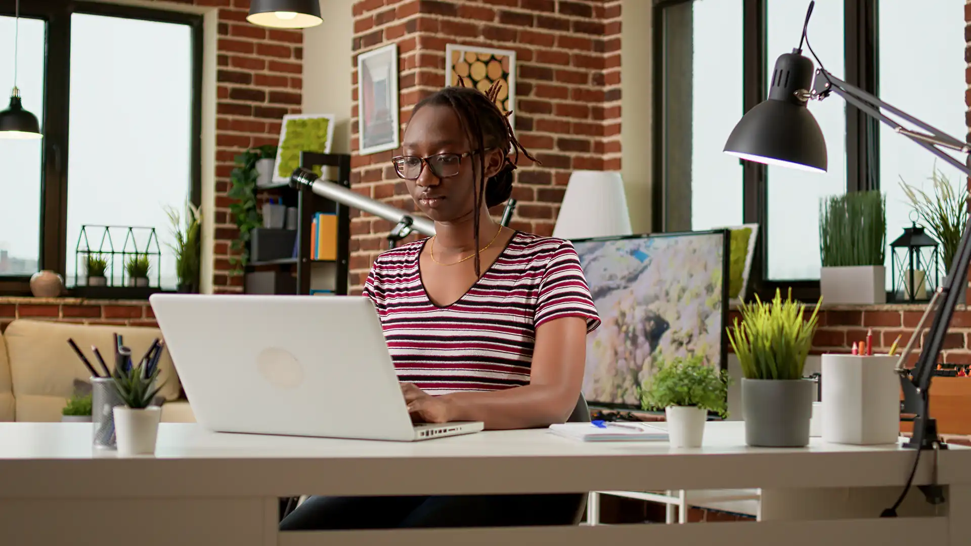 Creative professional organising design files on a laptop