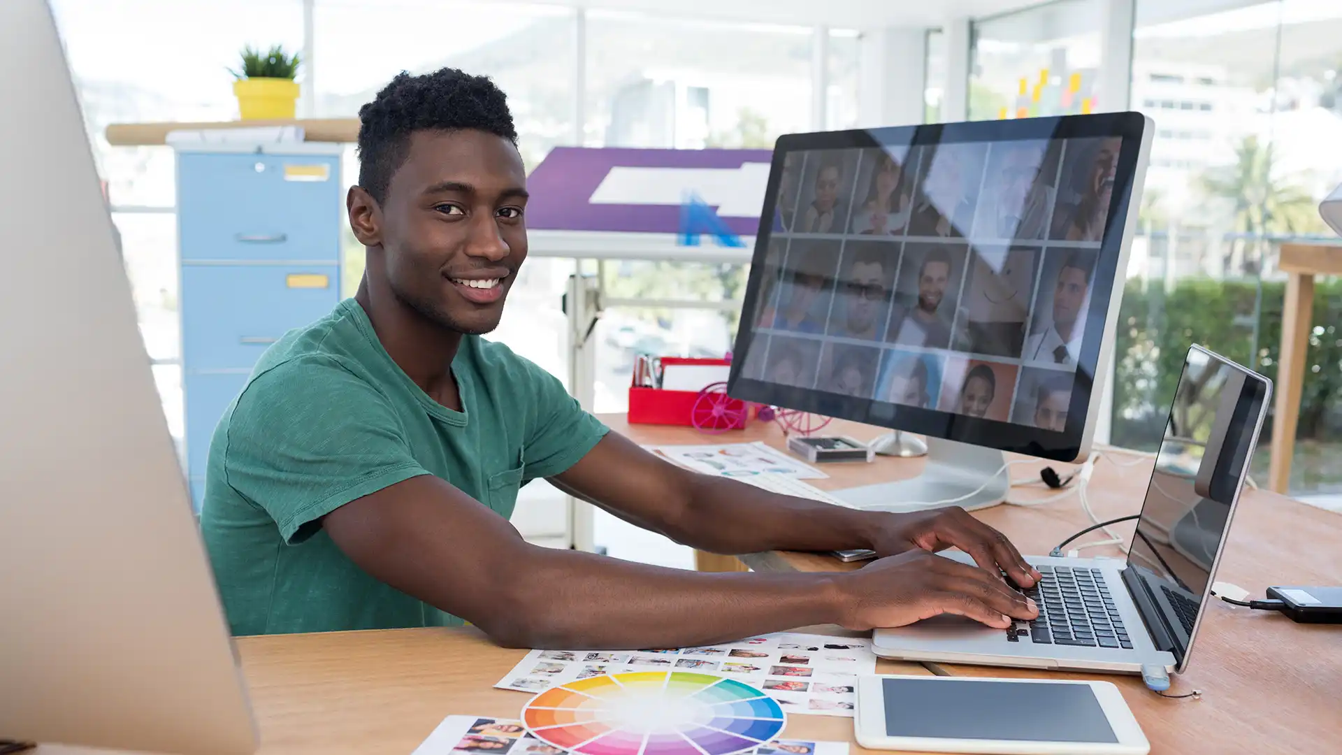 Graphic designer building a visual identity on a desktop workstation