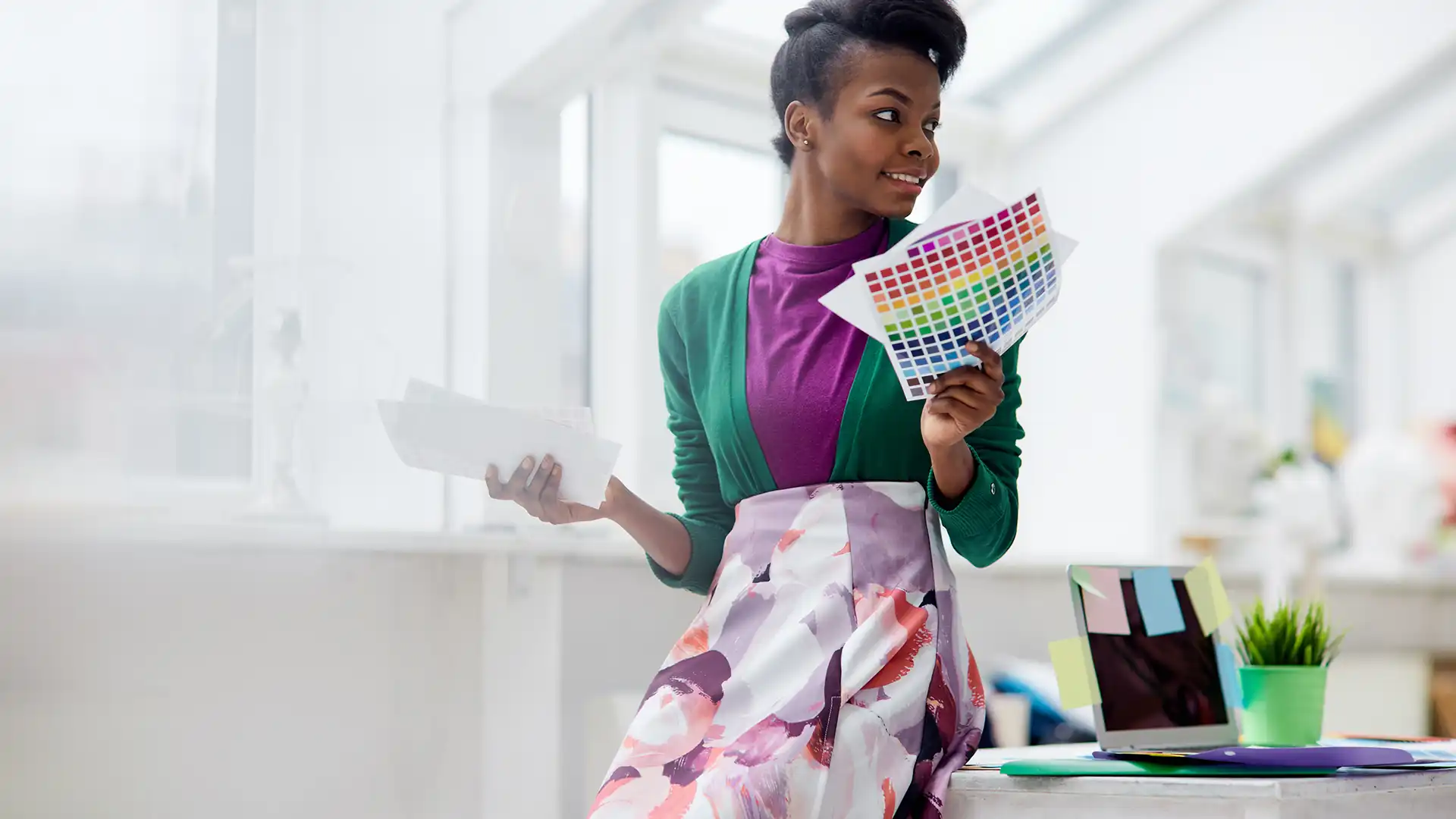 Designer reviewing brand colours in a bright studio