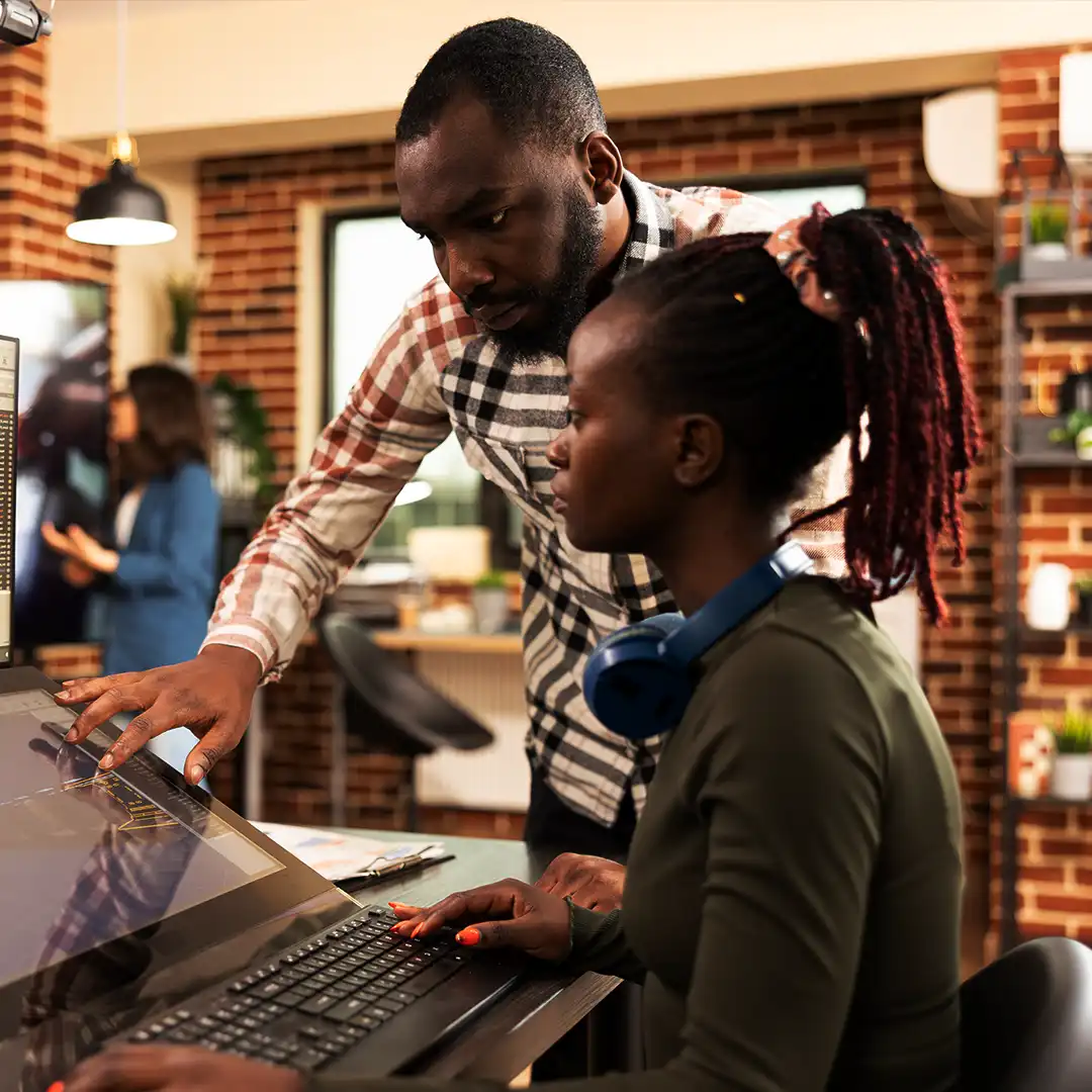 Team members collaborating at a design workstation
